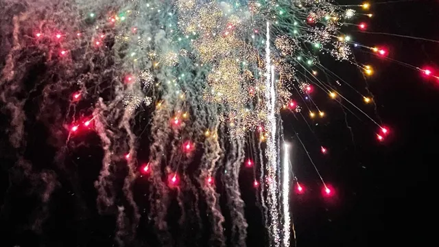Colorful fireworks bursting over the Destin Harbor near HarborWalk Village