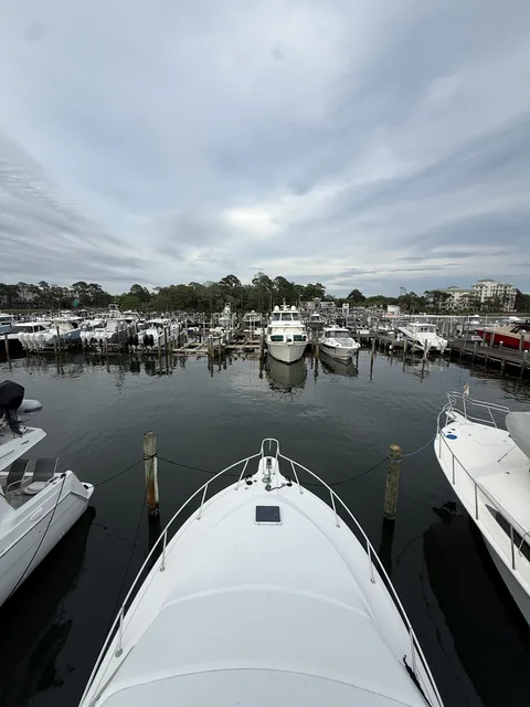 Charter boat backing out of the marina dock on an overcast morning in Destin