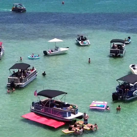 Private charter pontoon anchored on the shallow Crab Island sandbar in Destin