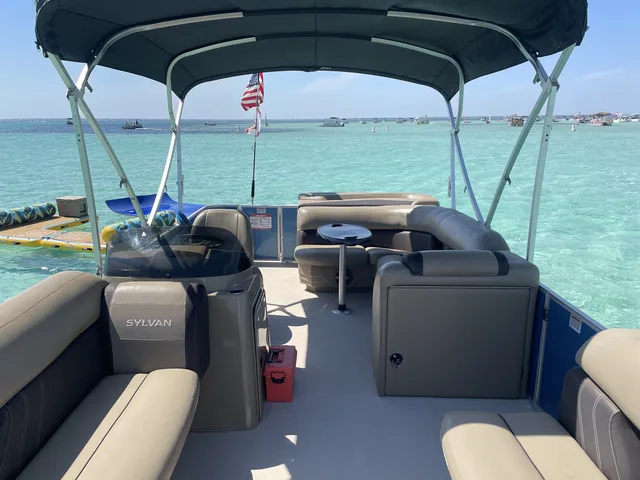 View from a pontoon deck overlooking the turquoise water and floating mat at Crab Island in Destin
