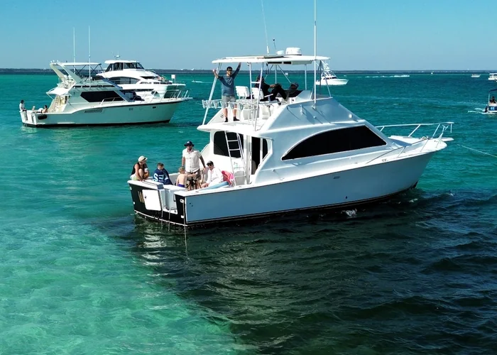 A sportfishing boat running past the East Pass sandbar during Destin’s fall fishing season